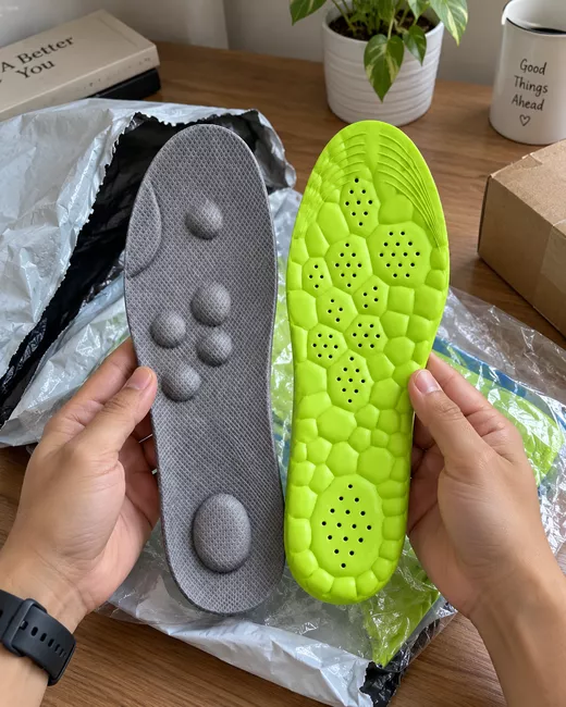 CloudSole insoles held over their packaging